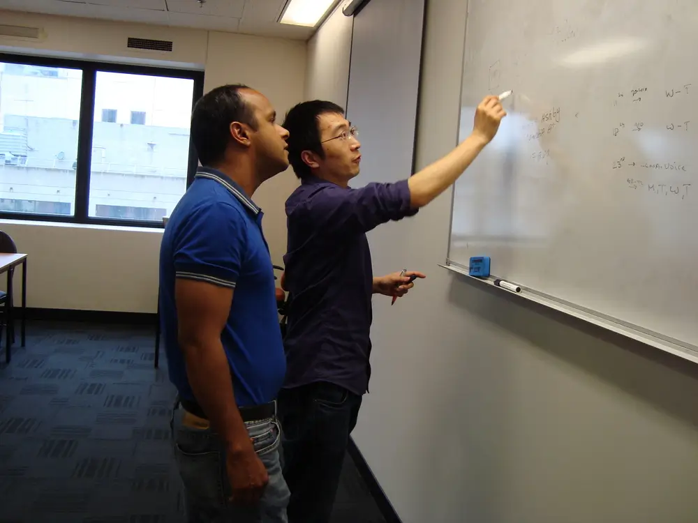 Explaining a concept at the whiteboard in a Melbourne IT course